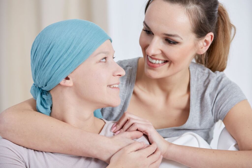 Hopeful cancer woman wearing headscarf, talking with friend