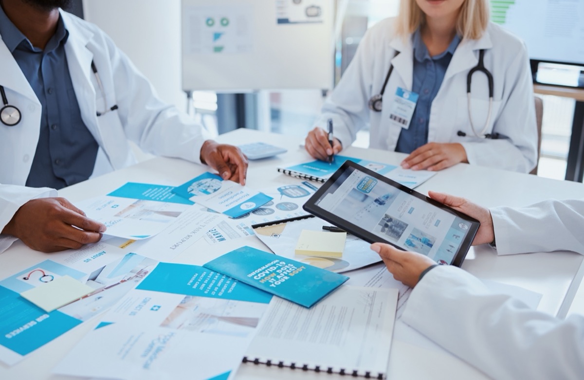 Healthcare professionals looking at information materials; medical affairs audits concept