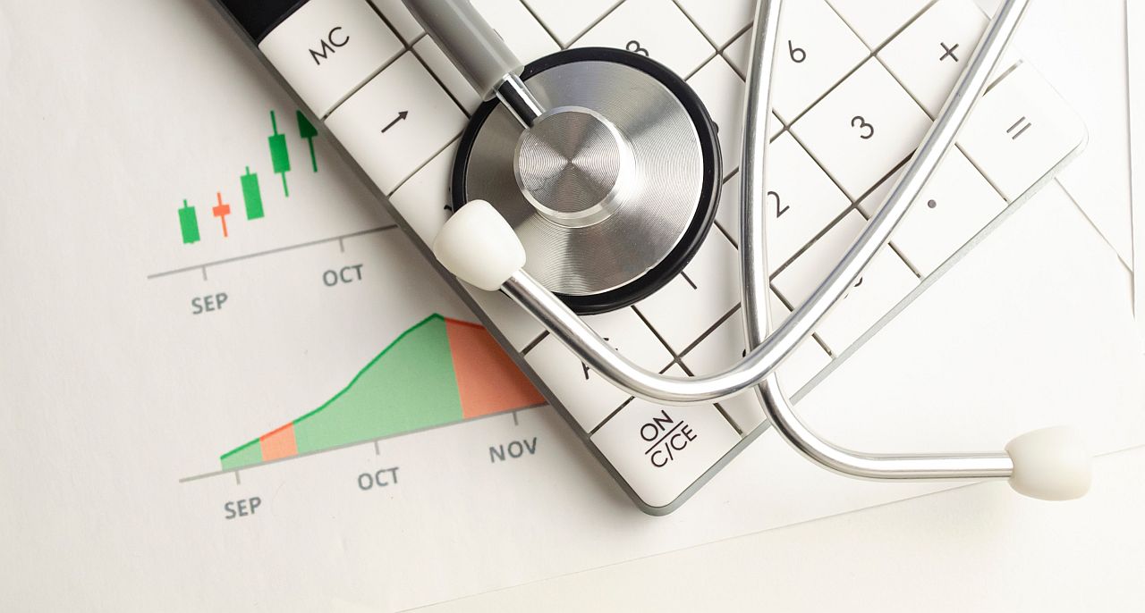 Stethoscope on top of calculated and graph; tech fatigue concept