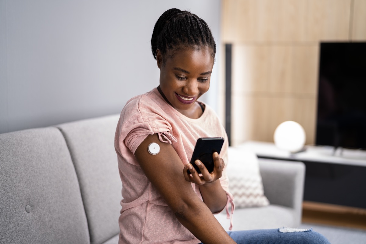 Woman Testing Glucose Level With Continuous Glucose Monitor; fda decentralized trials concept