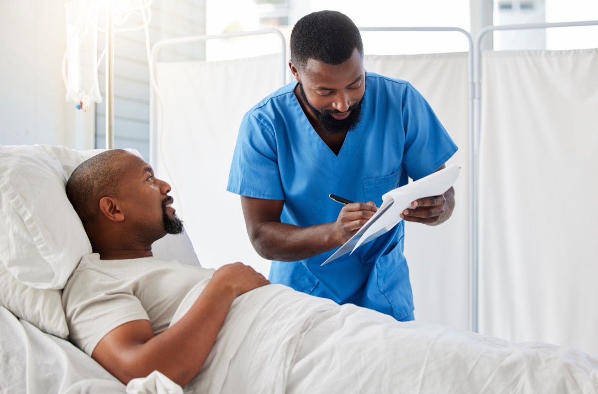 Healthcare professional and patient in hospital doing paperwork before surgery or during checkup; FDA diversity plan concept