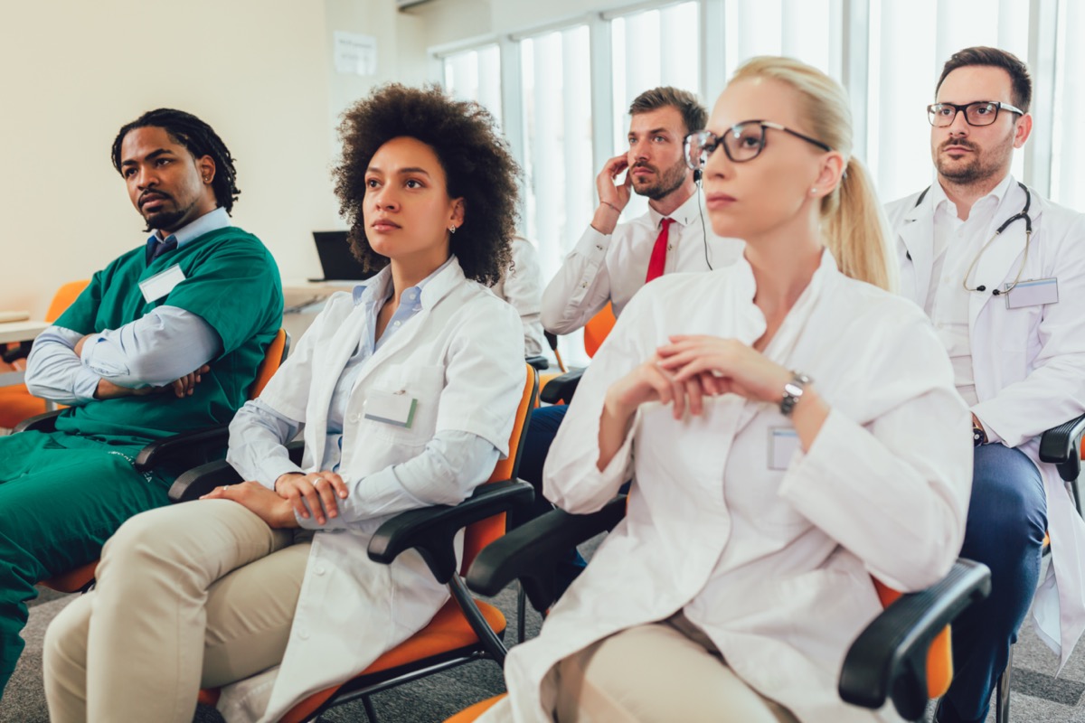 Group of doctors and healthcare professionals in lecture hall at hospital; KOL connections concept