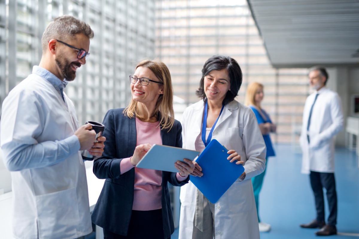 Group of doctors talking to pharmaceutical sales representative; KOL connections concept