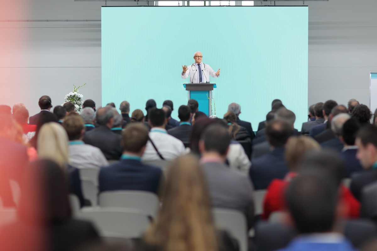 Doctor giving a speech on a stage at a conference; KOL identification concept