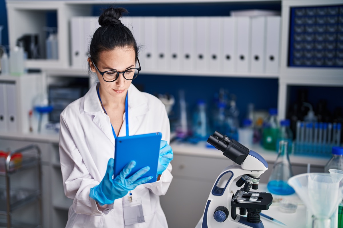 Scientist using touchpad in laboratory; regulations clinical researchers should track concept