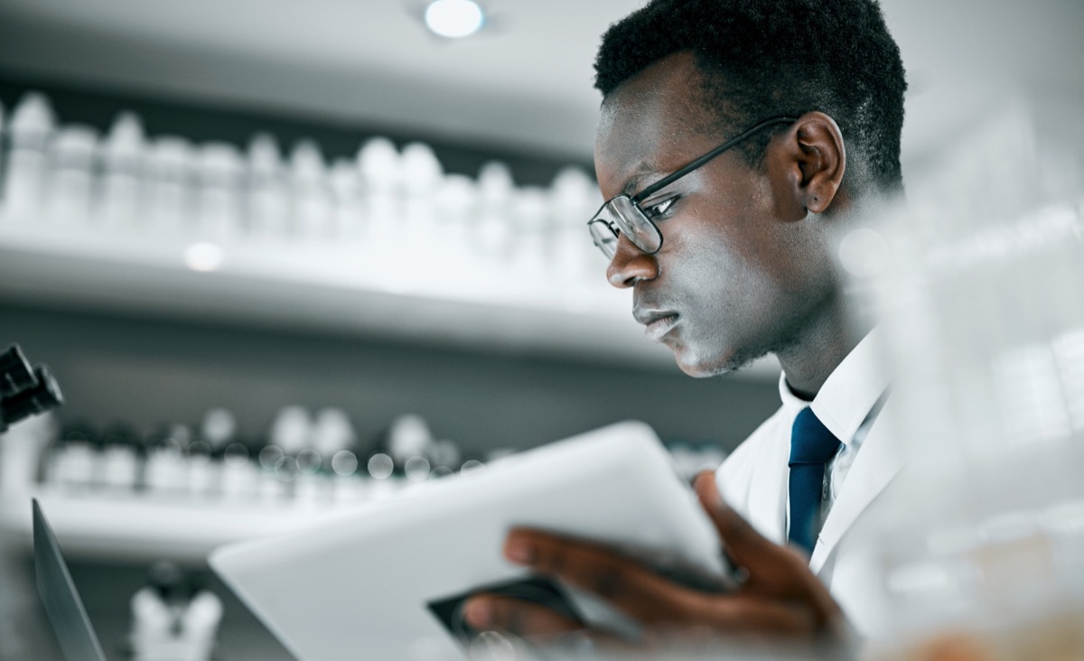 Scientist with tablet doing research; regulations clinical researchers should track concept