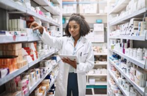 Pharmacist working in a pharmacy; clinical trial enrollment concept