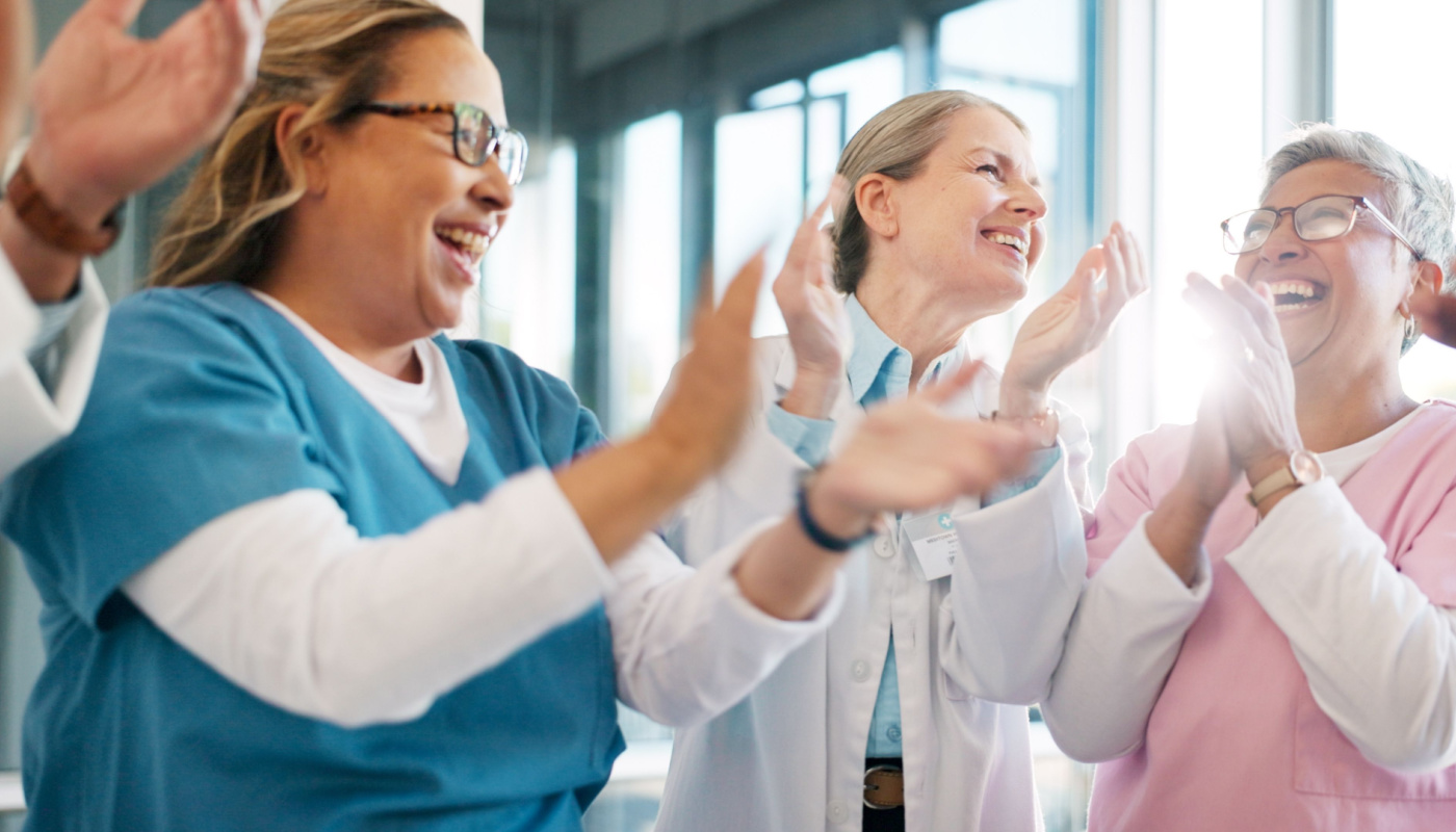 Doctor, support and applause in celebration for team unity, healthcare achievement or goal at the hospital. Group of medical professional clapping and celebrating teamwork,