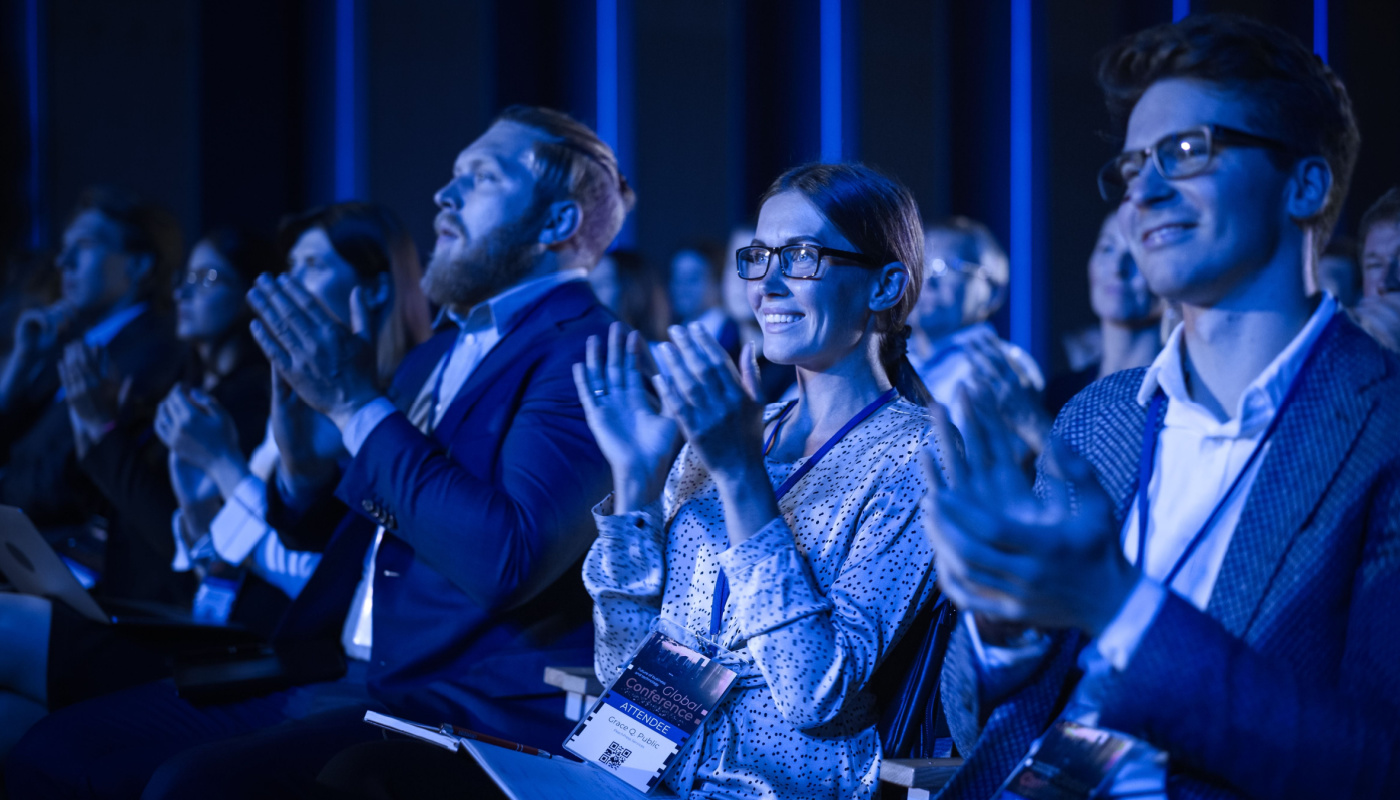 Audience applauding at conference; ISMPP Europe 2024 concept