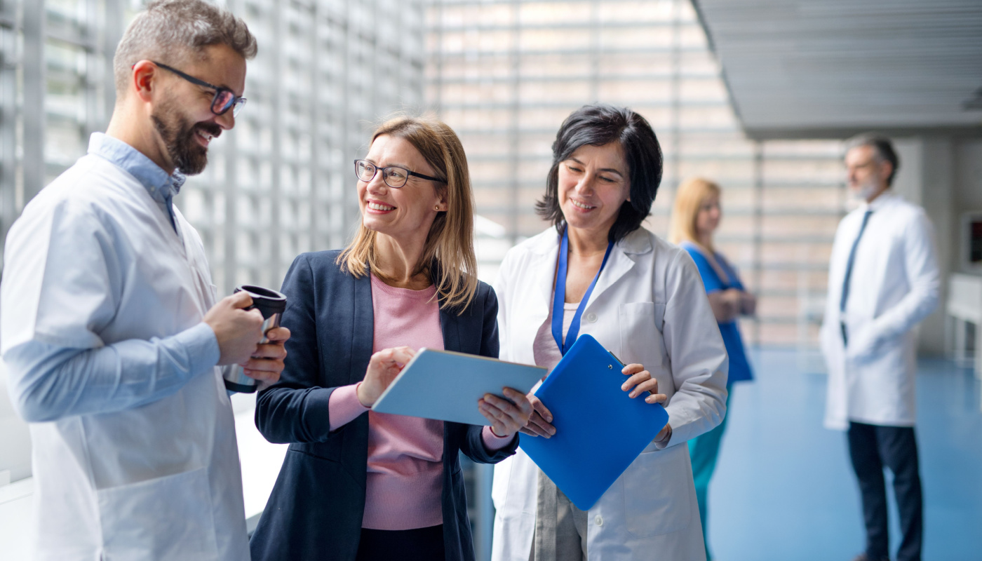 Group of doctors talking to pharmaceutical sales representative.; biopharma companies concept