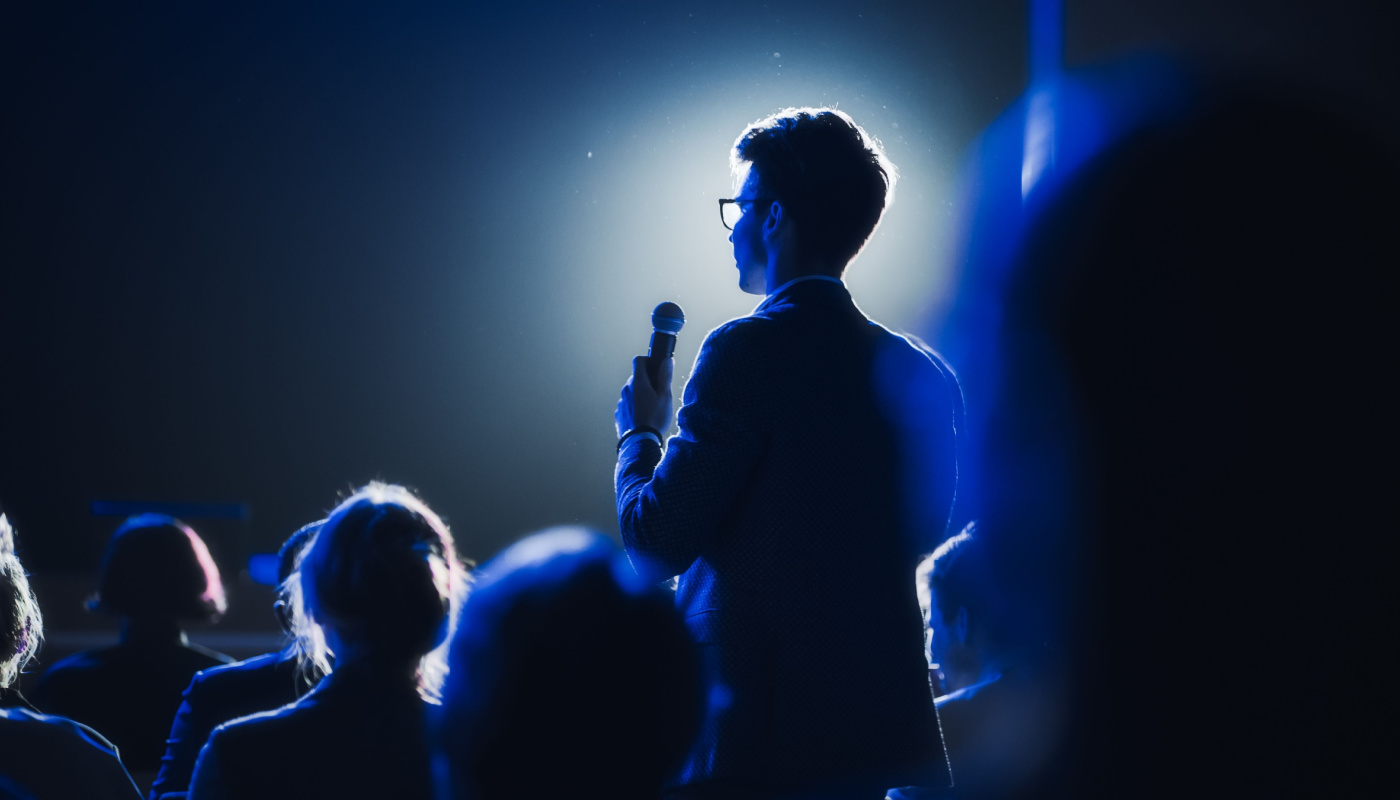 Audience member with microphone, speaking; SCOPE Orlando 2024 concept