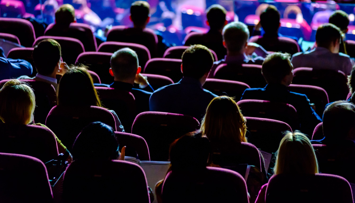 Audience listens to the speaker in a conference hall; SCOPE Orlando 2024 concept