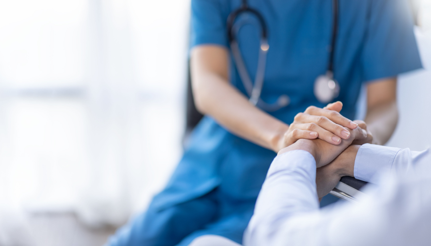 Healthcare professional hold a patient's hand; patient-centric care concept