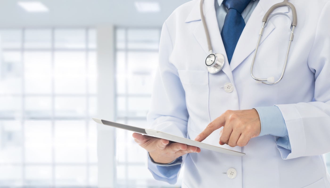 Doctor using digital tablet; patient-centric care concept