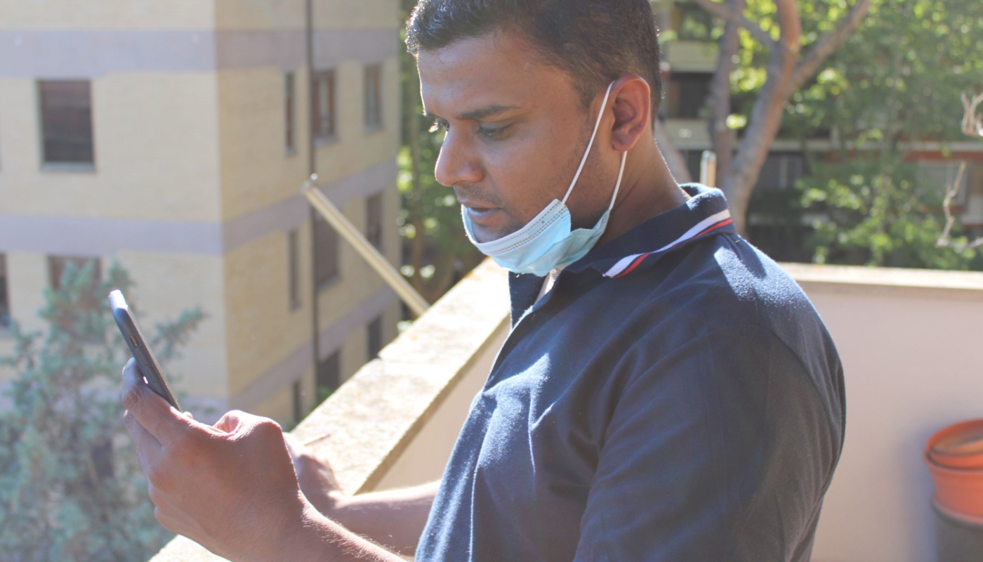 Patient with mask using cell phone; patient-centric clinical trials concept