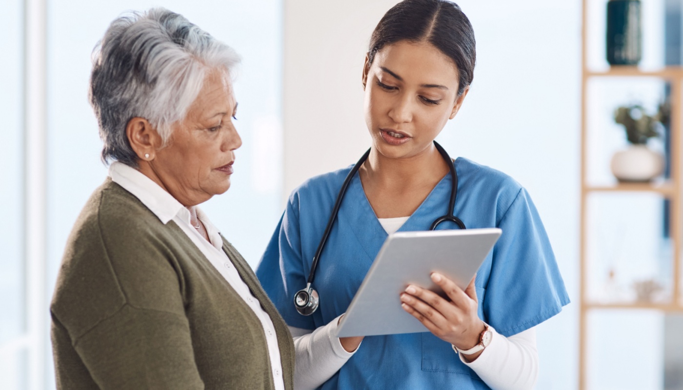 ANJ416 TWO Healthcare professional explaining findings on tablet to patient; patient-centric clinical trials concept