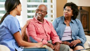 Healthcare professional gathering information during home visit; patient safety concept